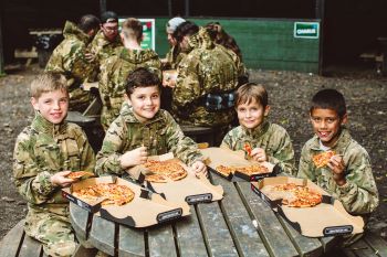 boys-sitting-at-table-with-pizza